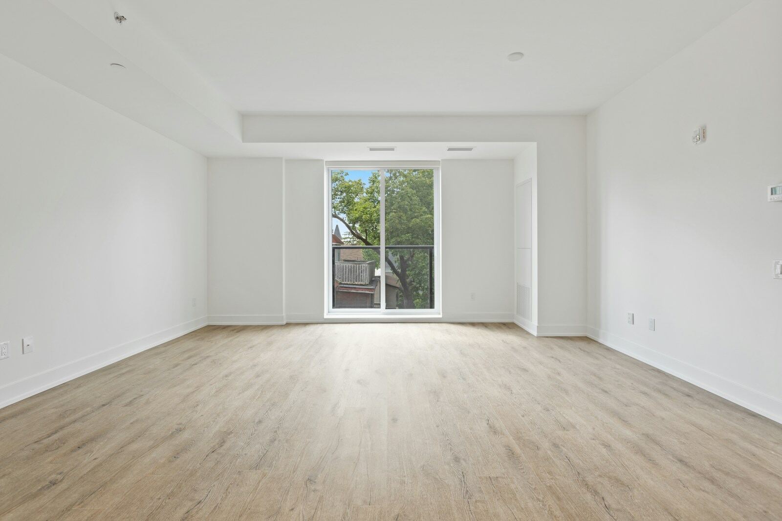 An empty bright room with clear floors and baseboards