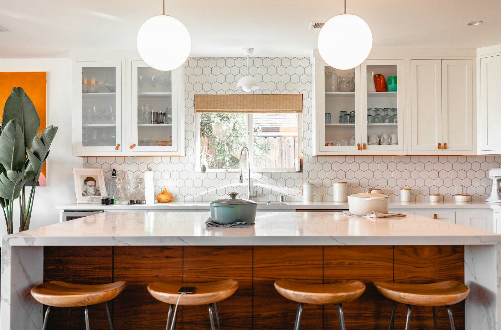 A tidy kitchen with clean counters, sink, and cabinetry